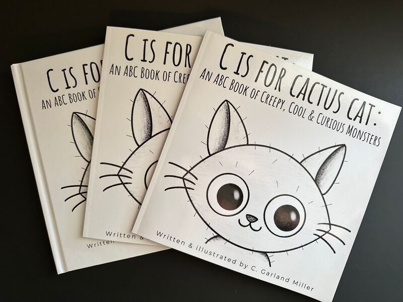 A stack of three C is for Cactus Cat picture books